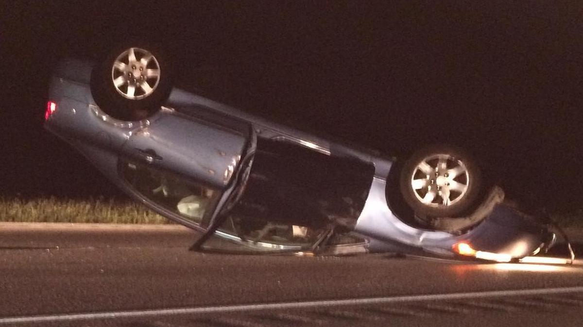 Lynai Williams was not injured when her car, shown here flipped over, hit a large bear Saturday night on Highway 101.