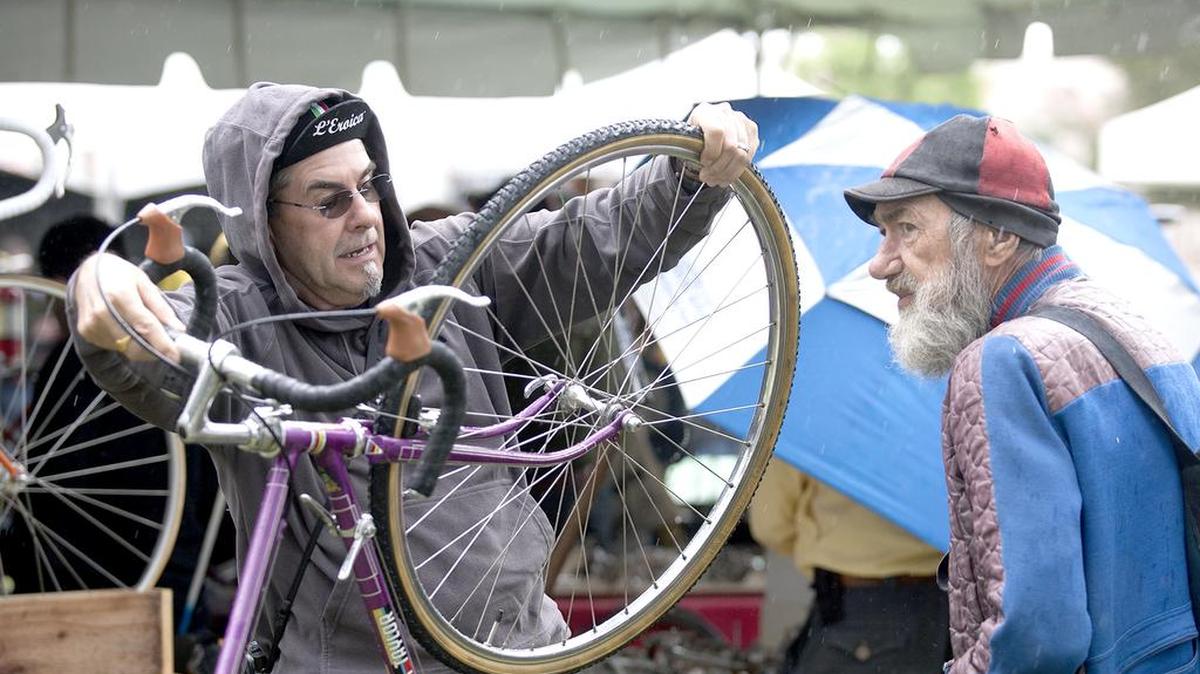Robert Scheive, left, of Orinda and Holland Jones of Chico look over and discuss a purple Jack Taylor bicycle at the swap meet.