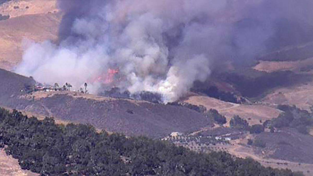 A grass fire burns in the hills east of Cambria on Sept. 6, 2022.
