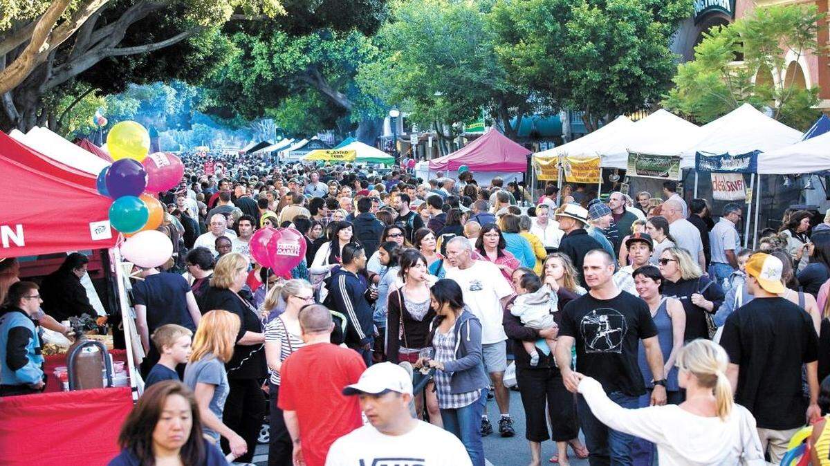 Crowds pack Higuera Street for the Downtown SLO Farmers Market on a warm summer evening in 2011.