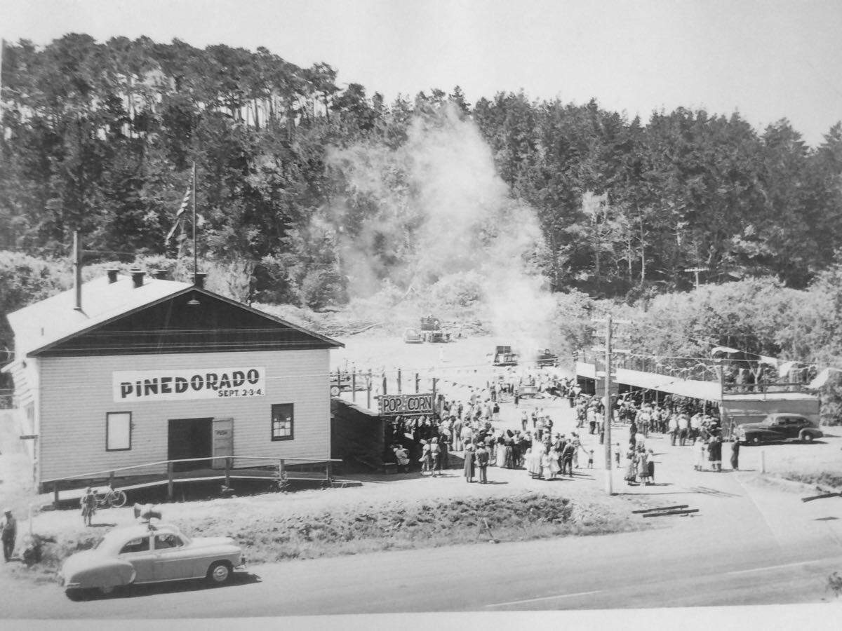 This Cambria Historical Society photo shows the Cambria Veterans Memorial Building, not long after it arrived in town in pieces and was reassembled, and an early Pinedorado celebration.