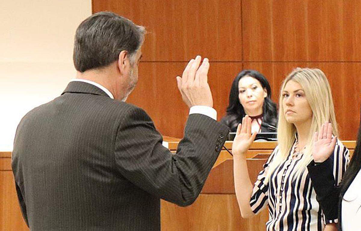 Fallyn Rollins, right, is sworn in as a deputy probation officer on April 26, 2019, at the Board of Supervisors’ Chambers in San Luis Obispo. She allegedly embezzled more than $100,000 from the probation department’s union and was charged with nine counts of grand theft by embezzlement on Feb. 4, 2025.