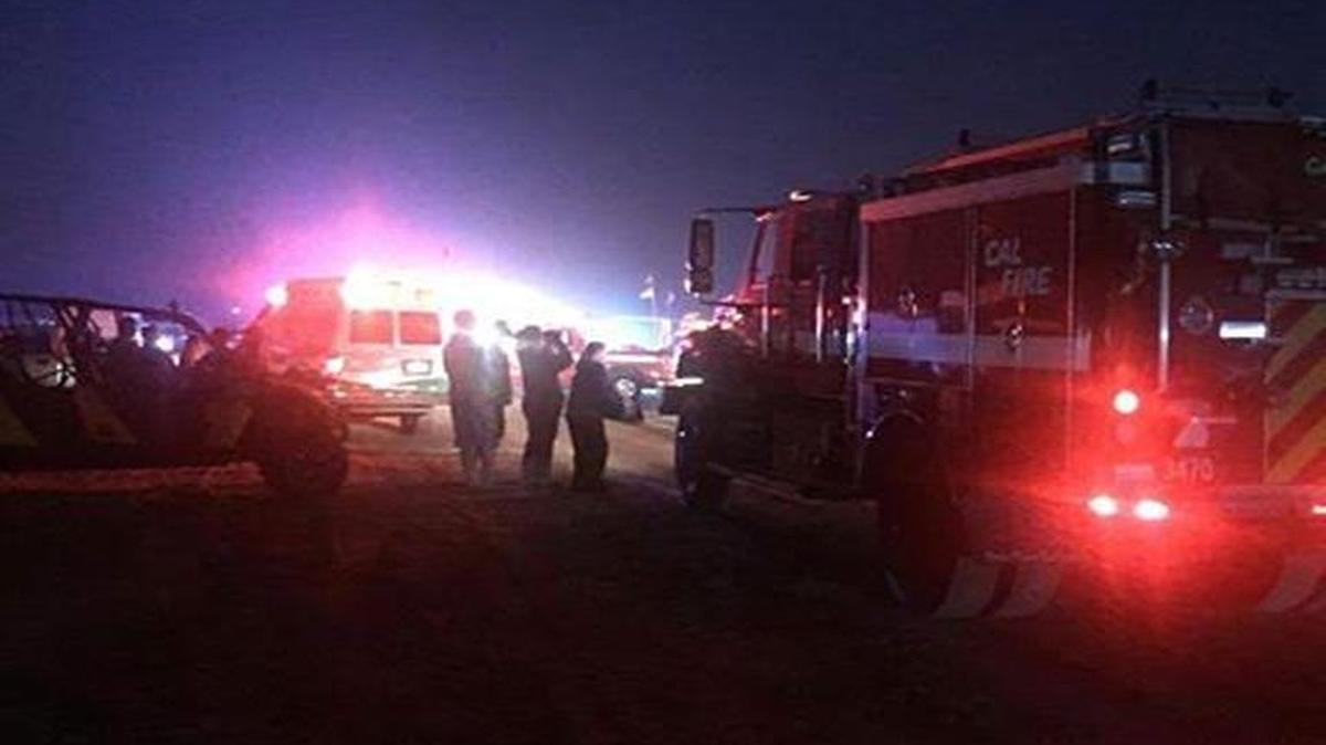 Rescue workers search for a swimmer in distress Sunday night at the Oceano Dunes.