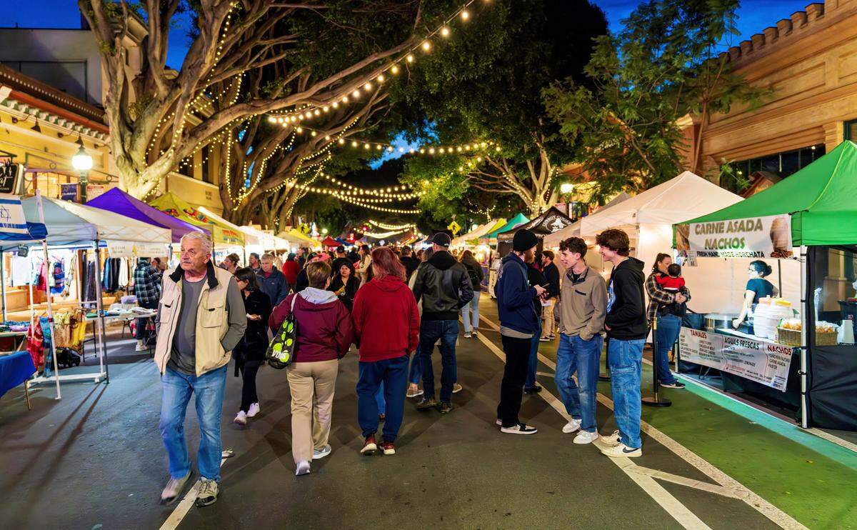People walk through Farmers Market in San Luis Obispo.
