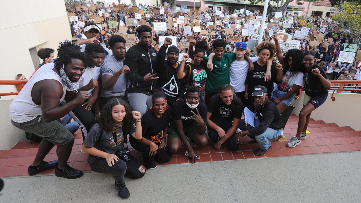 The rally was followed by a march lead the group that has organized previous marches who posed for a photo before leading a march around downtown.