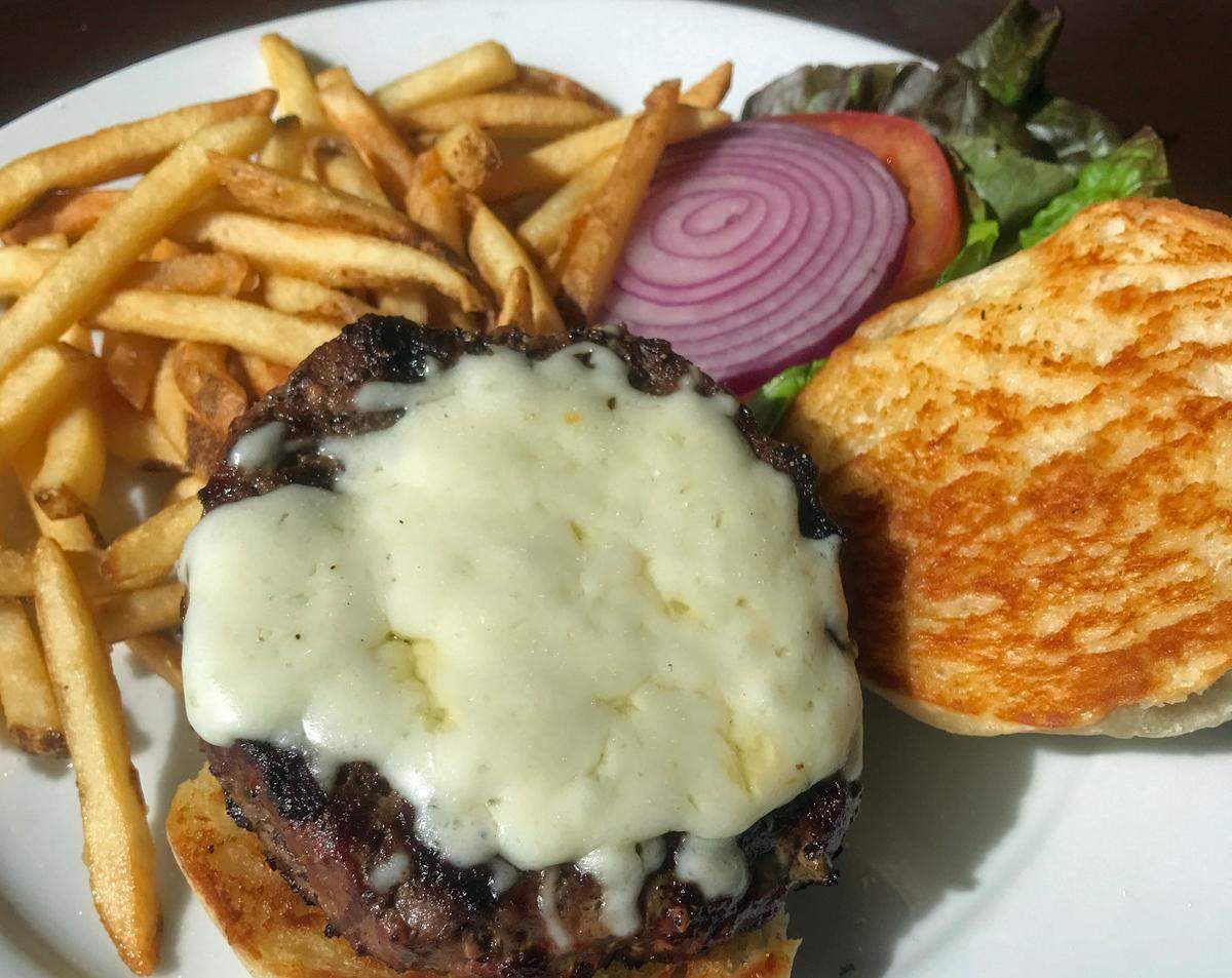 The half-pound, ground-sirloin burger with cheese is served on a sourdough bun at Dorn’s Breakers Cafe in Morro Bay.