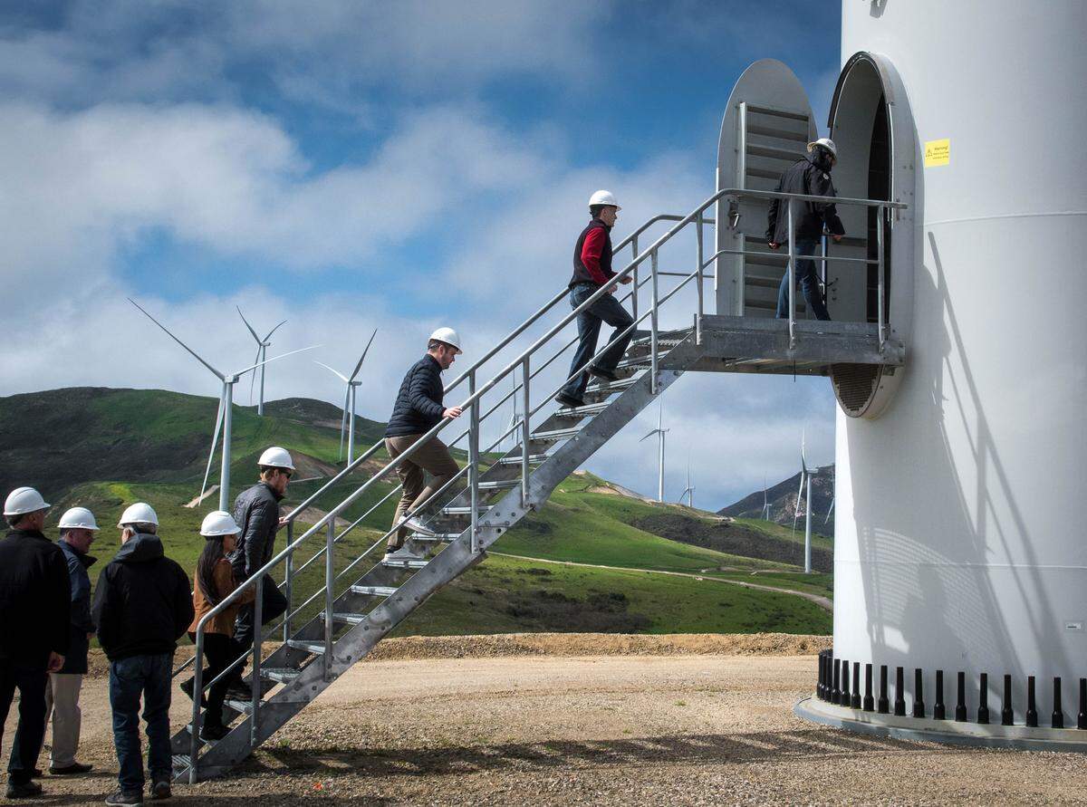 Visitors climb a staircase to enter a wind turbine Thursday at the official opening of the Strauss Wind Farm, near Lompoc.