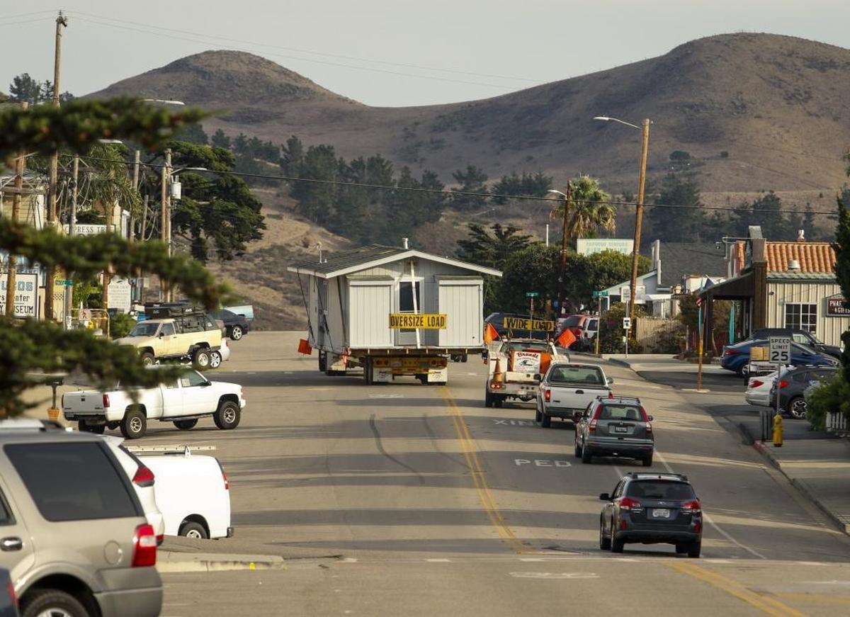 Scott James and his wife Gayle donated their Cayucos beach home to a woman who moved it across town on Monday with the help of Brandt House and Building Movers. Here, it makes its way down South Ocean Avenue toward its new home on 10th Street.