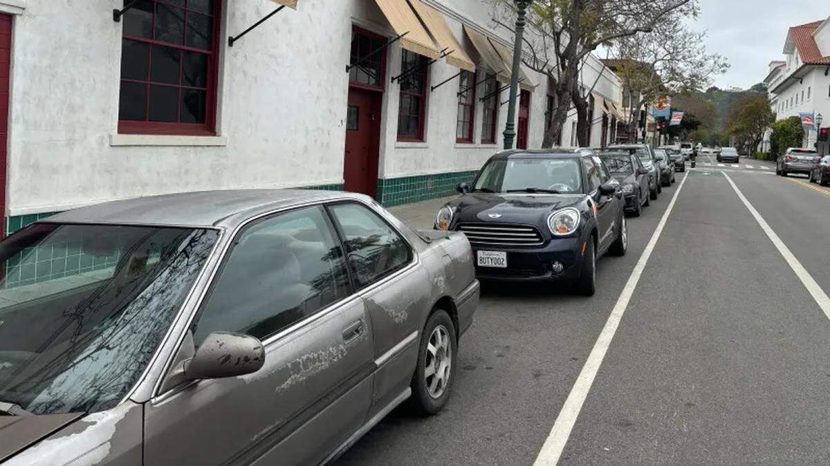 Vehicles are parked along Ortega Street in Santa Barbara, where city staff proposed limiting free parking to 15 minutes.