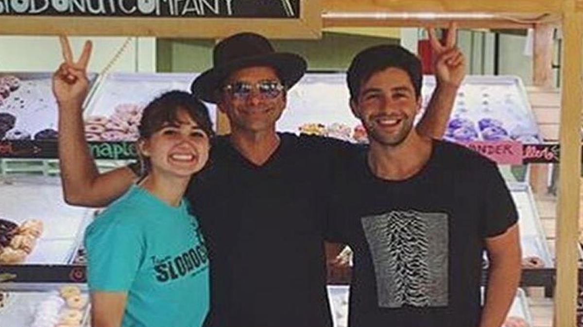 John Stamos and Josh Peck pose for a photo with employee Karen during the pair’s weekend visit to SLO Donut Co. in San Luis Obispo.