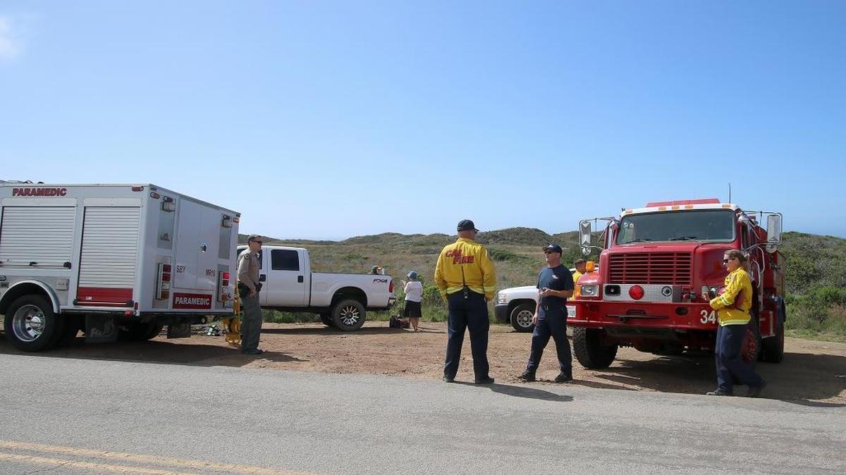 A male slipped on rocks and fell near the Hazard Canyon Reef area and was taken by helicopter to a hospital. Here, firefighters set up a staging area on Pecho Valley Road near the trailhead to the beach.