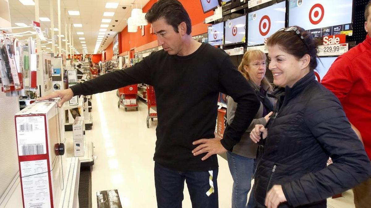Shoppers look for good deals at Target and Best Buy stores in San Luis Obispo Friday morning. Julie Acosta, right, of Los Osos and Rueben Moreno, of Santa Maria, check out a television on sale.