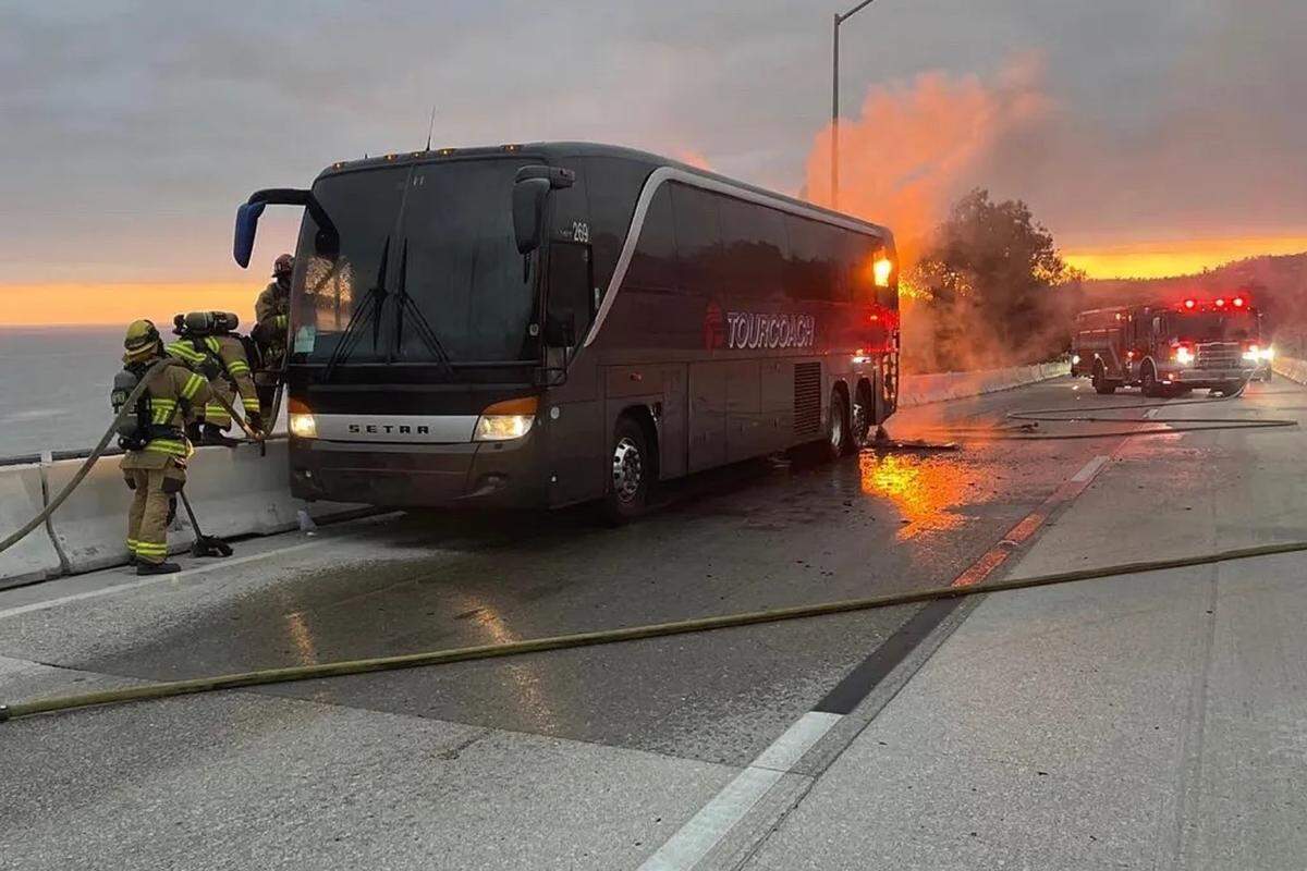 Montecito firefighters enter a burning tour bus on Highway 101 near the top of Ortega Hill east of Sheffield Drive. No one was injured in the fire. 