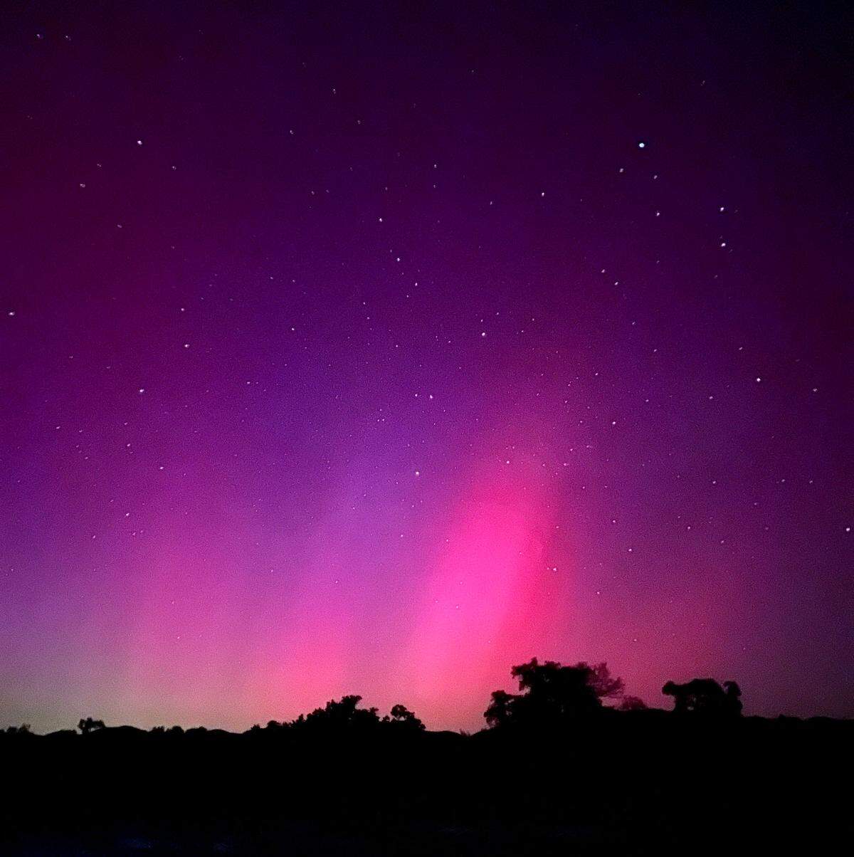 The northern lights illuminate the skies over Santa Margarita in pinks and purples on May 10, 2024.