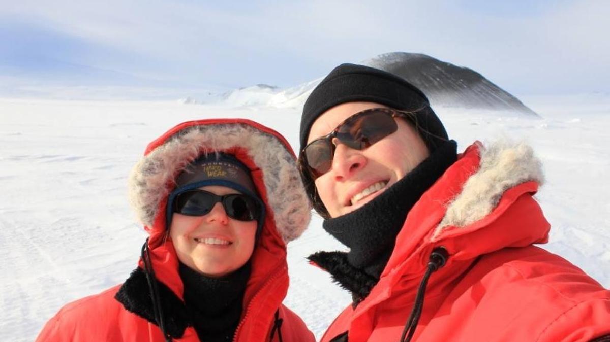 Heather Liwanag, left, and Linnea Pearson pose in front of Turtle Rock, in Antarctica in this photo posted on Oct. 5.