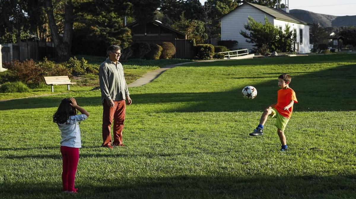 Javier de la Fuente plays soccer with his kids Mia, 5, and Lucas, 9, at the Los Osos Community Park.