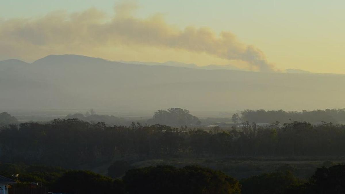 Spectators in Vandenberg Village watch smoke rise on the horizon from the Canyon Fire burning Saturday evening on Vandenberg Air Force Base.