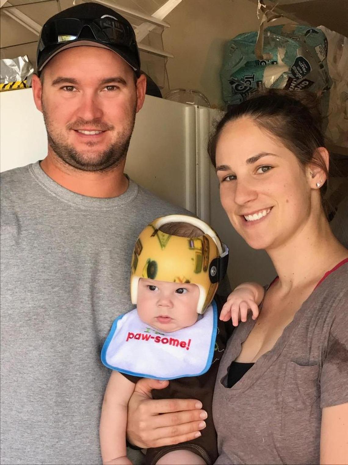 Rebecca and Andrew Jones of Paso Robles pose for a photo with their son, Jace, who suffers from Wiskott-Aldrich syndrome, a genetic disorder that compromises his immune system. Jace wears a helmet to protect his head from bumps that may cause bleeding issues.