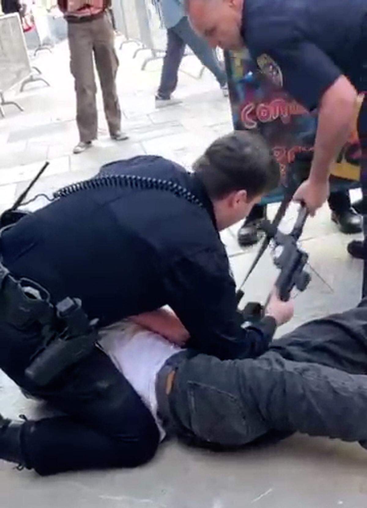 A San Luis Obispo police officer arrests a protester during an pro-Palestine demonstration at Cal Poly on Jan. 23, 2024.