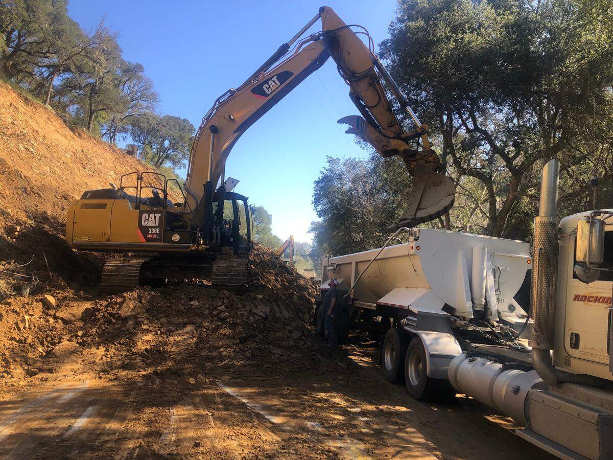 A loader fills a dump truck with dirt on Highway 41 between Atascadero and Morro Bay, on Sunday, March 26, 2023.