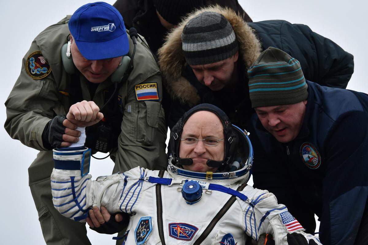 Ground personnel help International Space Station crew member Scott Kelly of the U.S. to get off the Soyuz TMA-18M space capsule after landing near the town of Dzhezkazgan, Kazakhstan, in 2016. Kelly and Russian cosmonaut Mikhail Kornienko returned to Earth after spending almost a year in space in a ground-breaking experiment foreshadowing a potential manned mission to Mars.
