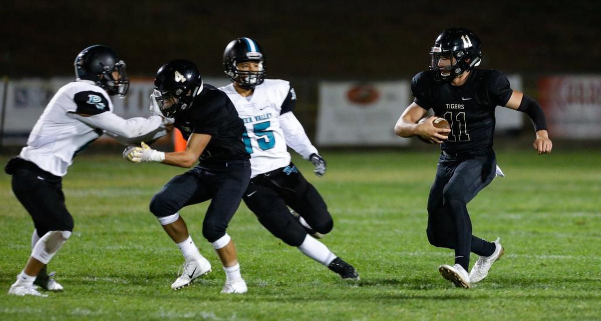 San Luis Obispo High School quarterback Emilio Corona carries the ball as Anthony Arroyo blocks against Pioneer Valley on Friday night.