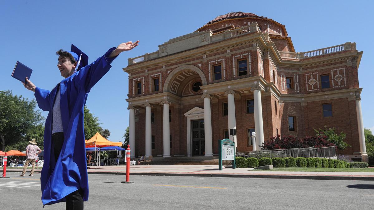 David Kirkland of Paloma Creek High School poses for a photo near Atascadero City Hall after his graduation. The city’s three high schools coordinated to provide a combined drive-through graduation due to coronavirus restrictions prohibiting mass gatherings.