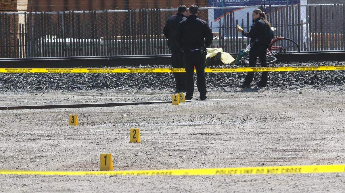 Paso Robles police investigate the scene where Donald Frank Hughes was found dead Friday on the railroad tracks near 6th and Pine streets.