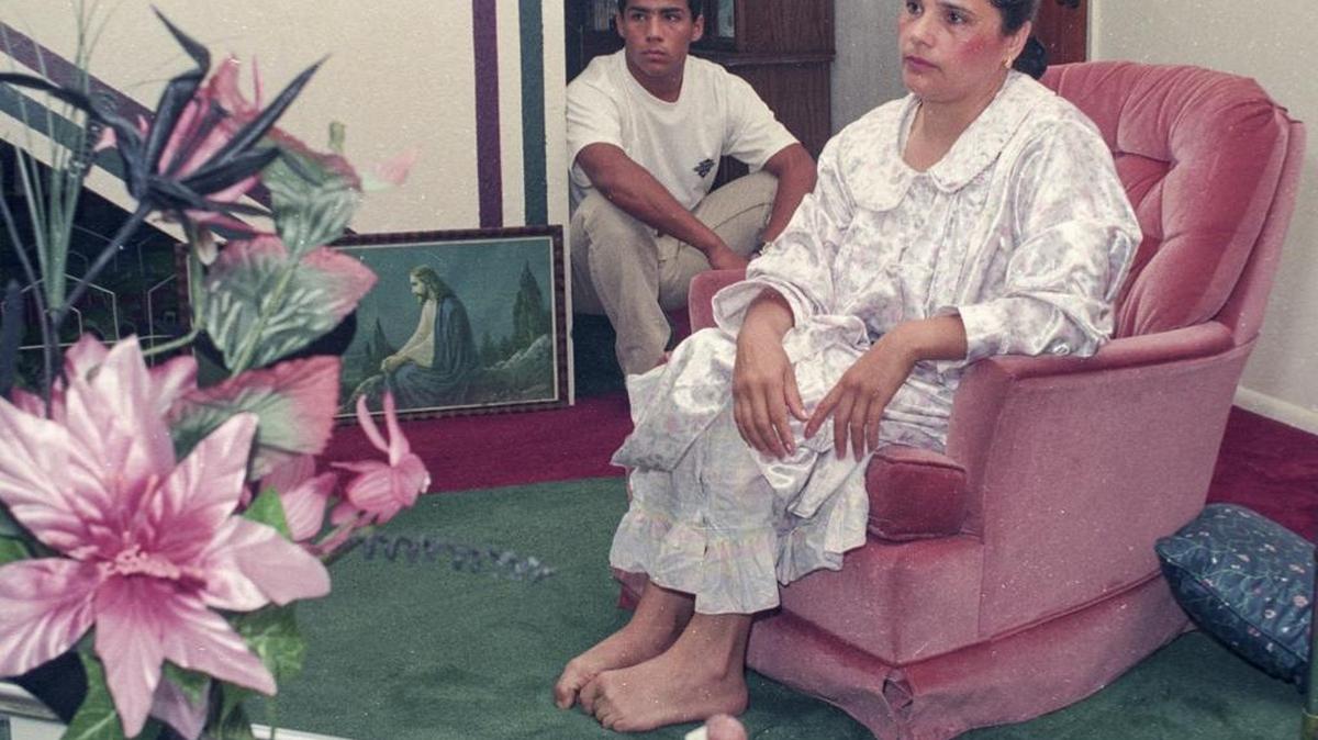 Oscar Higueros Jr. and his mother Graciela Higueros pose for a photo in the living room of their Los Osos home in May 1992. Two years earlier, sheriff’s deputies found Oscar Higueros Sr. in that living room, the victim of a fatal stabbing. Higueros Jr. is currently on trial in a human trafficking case.
