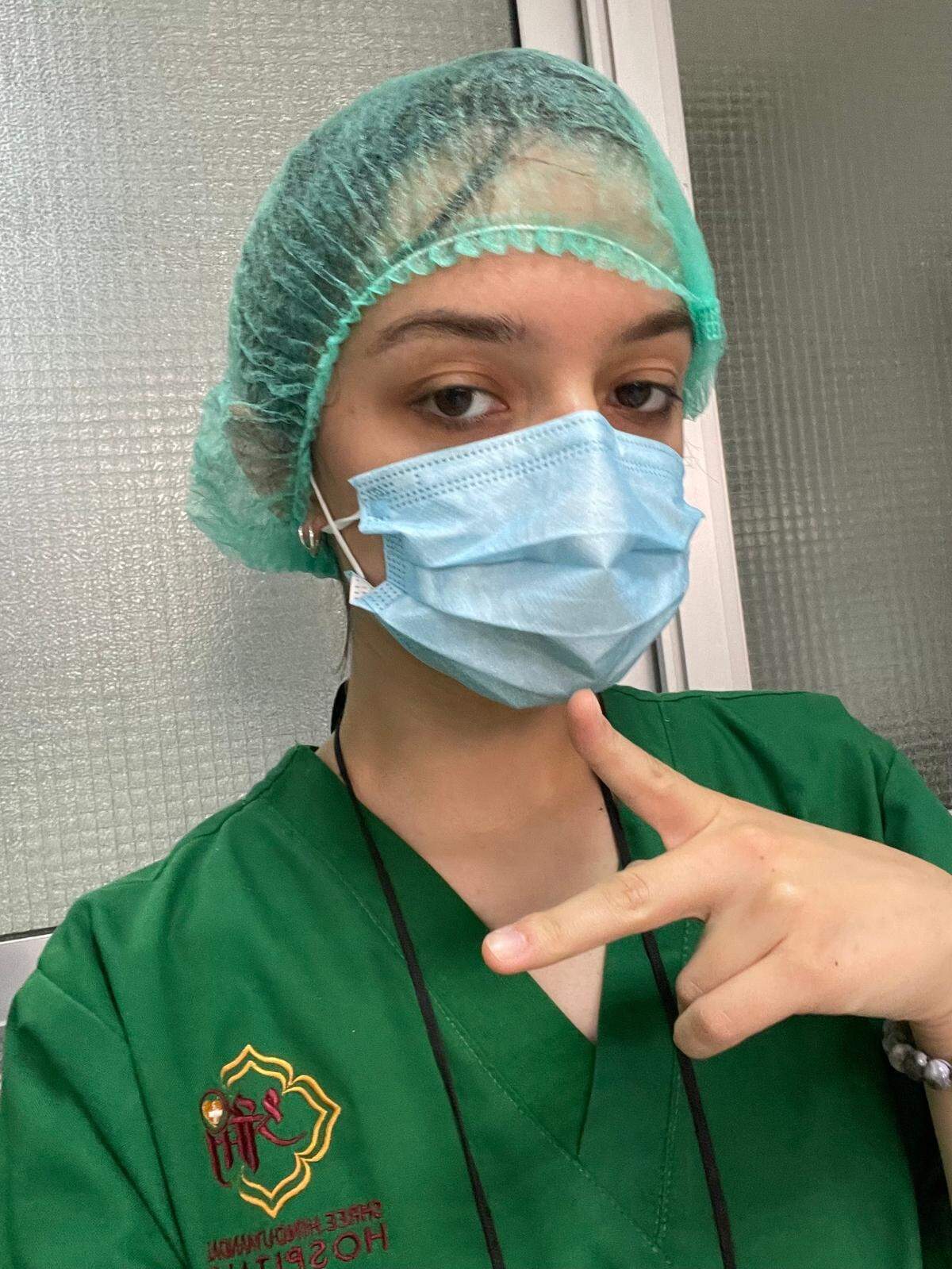 Shanyra Cardenas of San Simeon, a Coast Union High School student, flashes a peace sign during one of her rotation shifts at the Shree Hindu Mandal Hospital in Dodoma, Tanzania, in July 2022. Her two-week work/visit was part of the FutureDocs Abroad program.