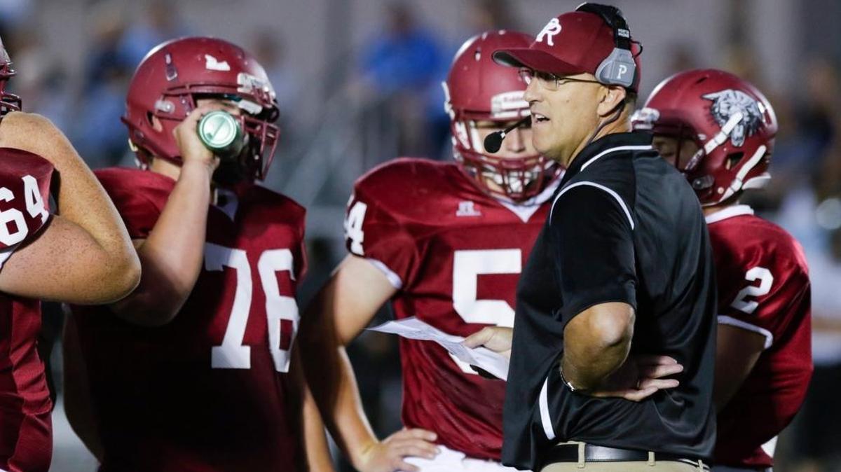 Paso Robles High football coach Rich Schimke talks to players during a game against Clovis North in September.