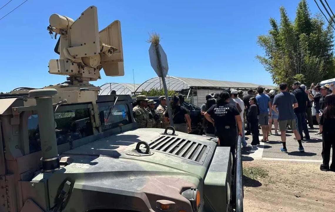 A crowd confronts federal agents conducting an immigration enforcement operation at a Carpinteria cannabis farm Thursday, July 10, 2025. Ten workers were reportedly detained.