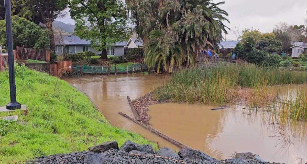 Laguna Lake rose well above its usual elevation during a storm, and spilled out underneath Madonna Road, on Feb. 19, 2024. The overspill also fed to the area below the Froom Ranch Way bridge near Dick’s Sporting Goods, creating a fast-moving creek.
