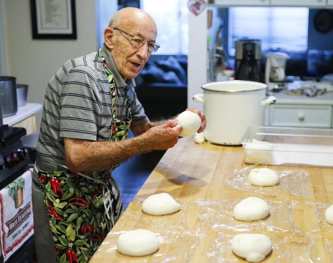 Retired San Luis Obispo pediatrician Louis “Lou” Tedone wraps up pound-size portions of fresh mozzarella cheese. He makes dozens of balls of mozzarella every morning for his daughter and son-in-law's deli, DePalo & Sons in Shell Beach.
