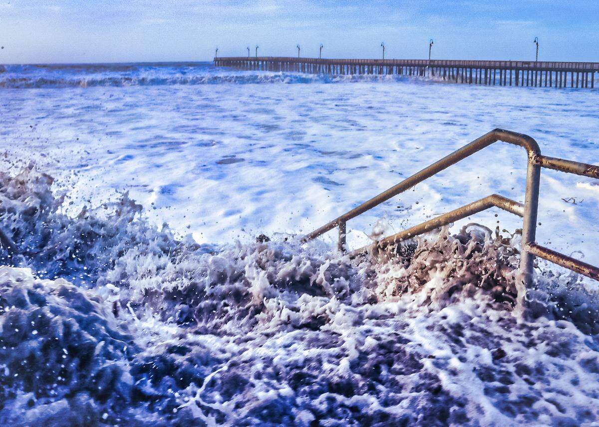 High surf inundates a staircase to the beach in Cayucos on Jan. 5, 2023, after a powerful winter storm moved through the area.