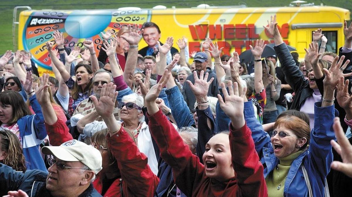 “Wheel of Fortune” fans shout out the title of their favorite show during a 2005 stop by the Wheelmobile at Perry Ford in San Luis Obispo.
