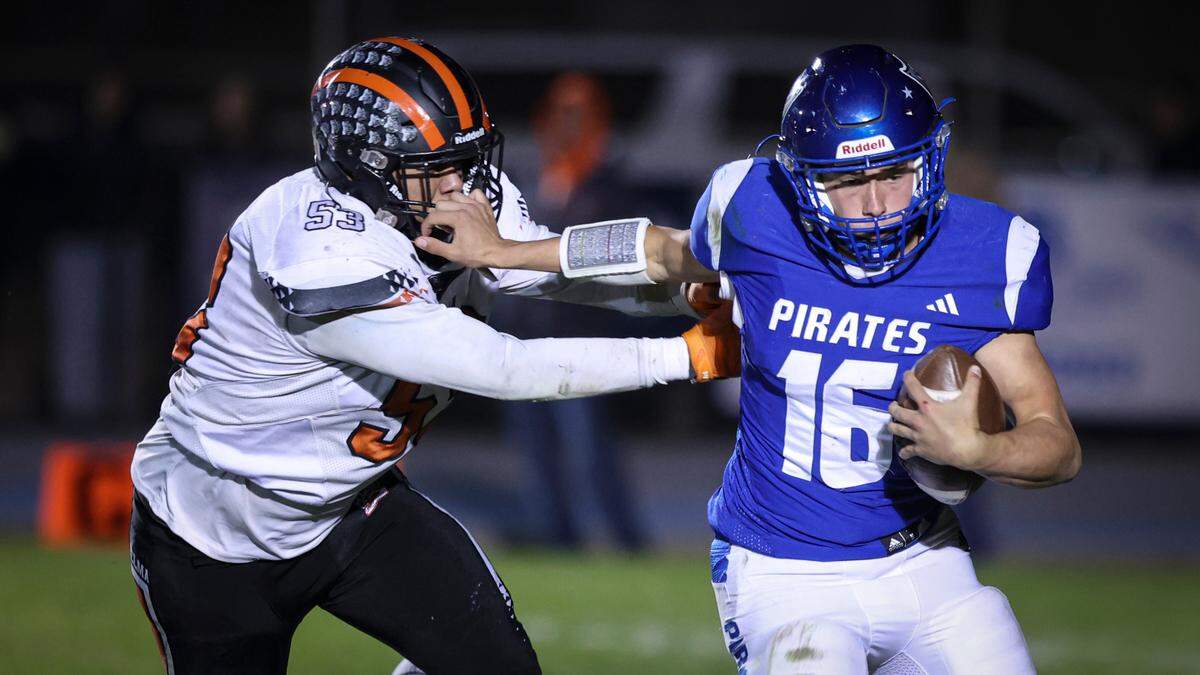 Matheo Roque puts pressure on quarterback Sands Dougherty. Selma held off a last minute drive by Morro Bay to win the CIF Central Section Championship 32-28 on Nov. 27, 2023. Dougherty threw for more than 4,000 yards on the season.