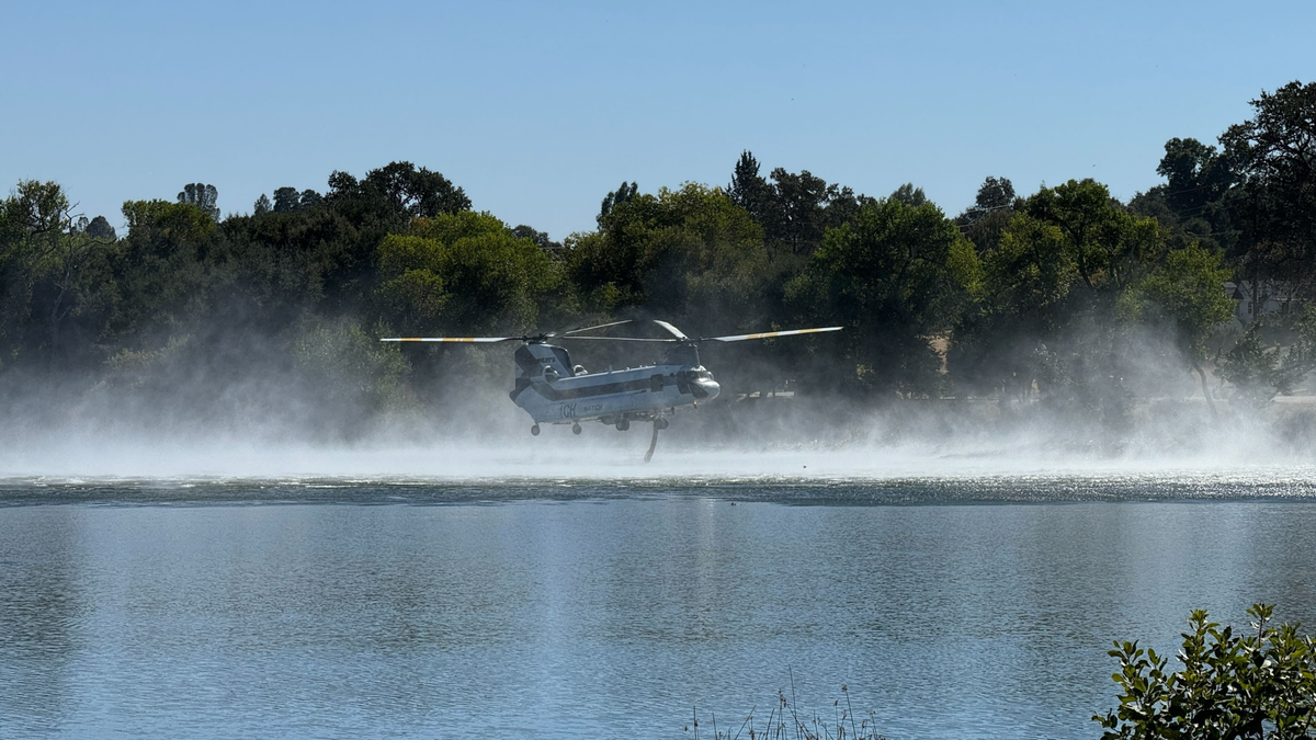 A helicopter was spotted getting water at Atascadero Lake to help put out the 30-acre fire in San Luis Obispo on Oct. 19, 2024.