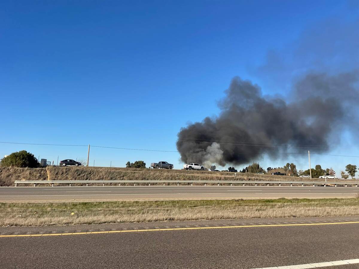 A fully involved RV fire sent up a plume of black smoke in east of the Paso Robles Municipal Airport on Jan. 10, 2025. 