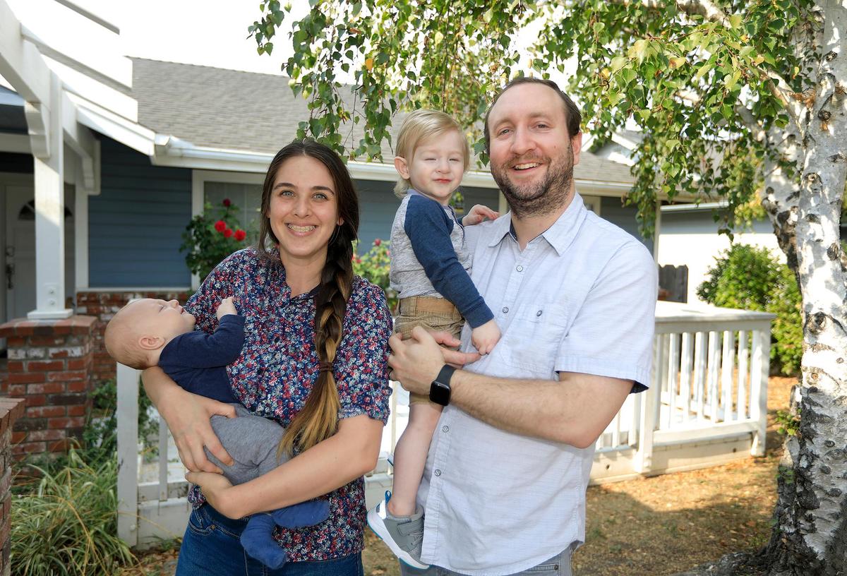 Kristine Disselhorst and her husband, Paul, bought a house in SLO recently, among many others from out of the area. They’re pictured in front of their home with children George and Rowan.