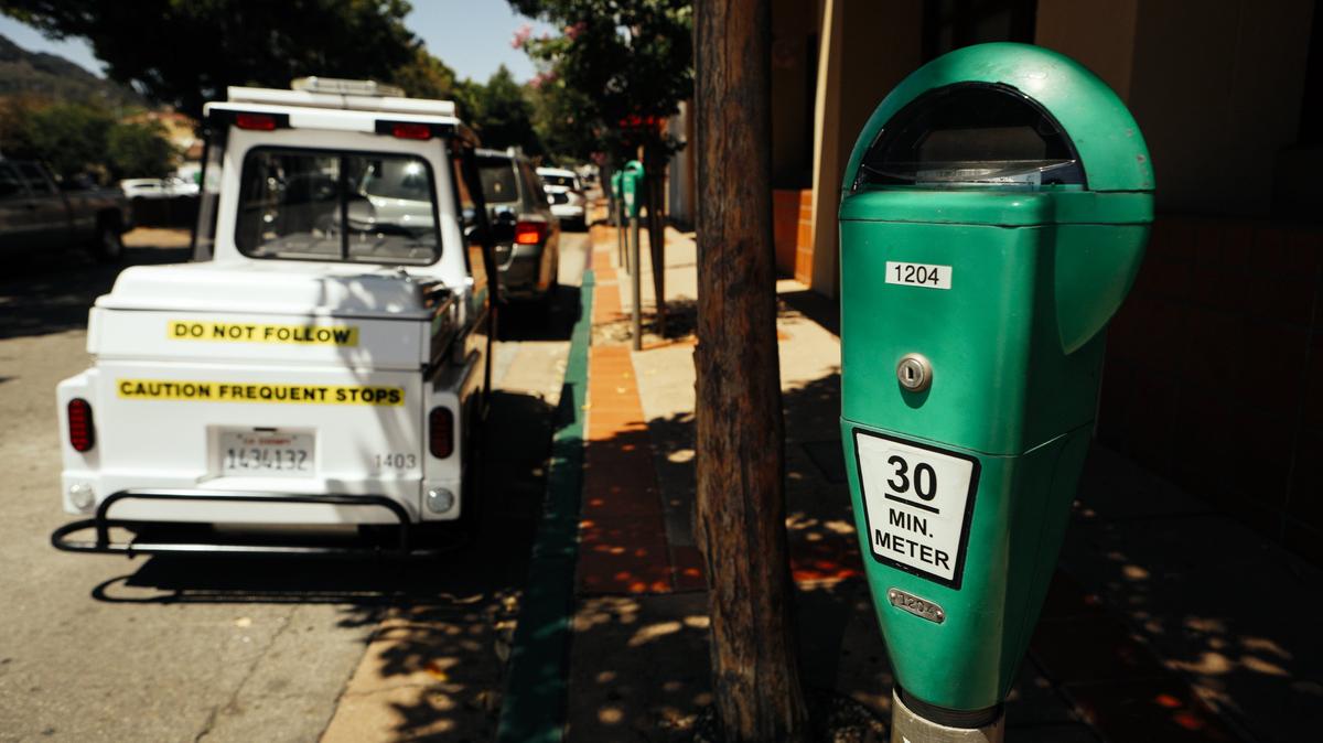 A San Luis Obispo parking vehicle pauses near a 30-minute meter in downtown. Officers are using a new automated camera system that captures images of parked cars and license plates for more accurate parking enforcement.