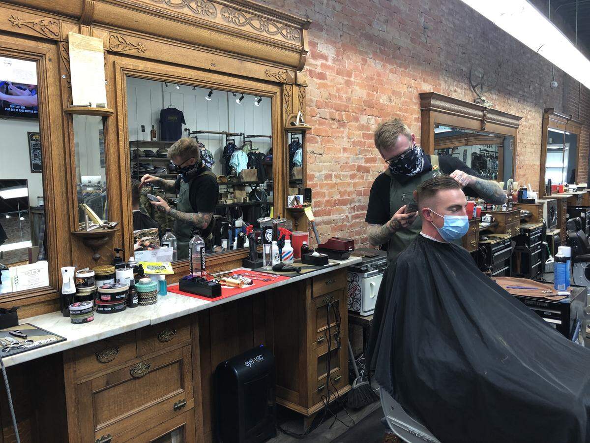 Jarrett Wininger cuts a customer’s hair at The Ritual in downtown SLO.