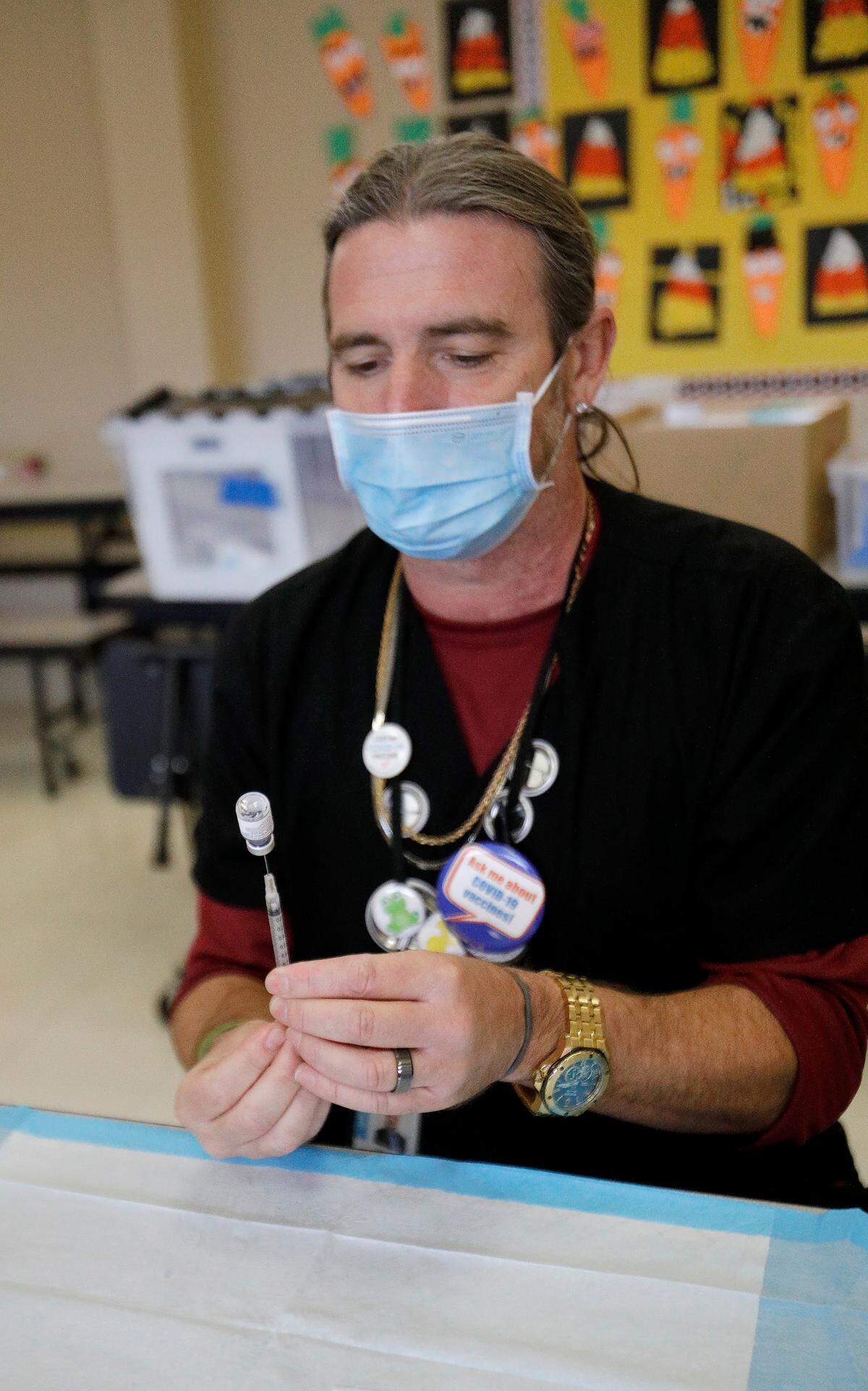 San Luis County Health Department Psych Tech John “Mike” Jamison readies COVID-19 vaccination syringes. The health department conducted a pop-up vaccination clinic at Santa Rosa Academic Academy in Atascadero, Friday, Nov. 3, 2022.