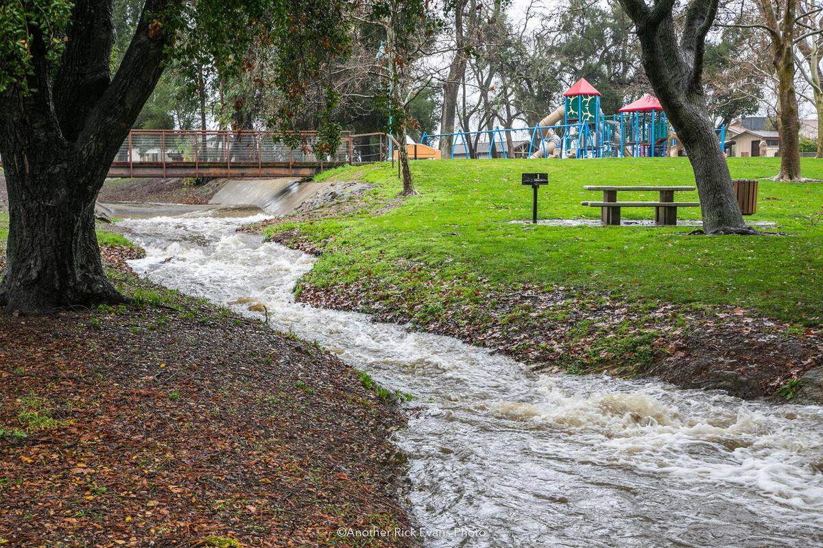 Atascadero Lake overflows into its spillway on Jan. 9, 2023.