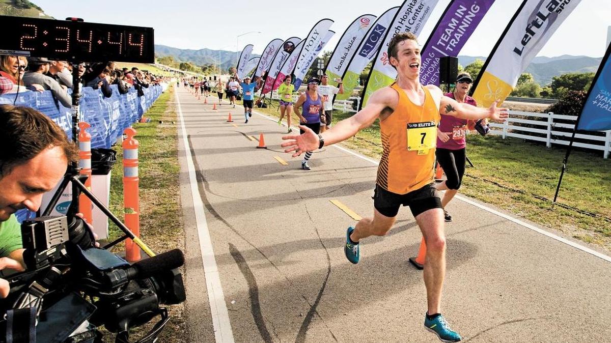 Ryan Neely, men’s winner of the 2014 San Luis Obispo Marathon, heads to the finish line at the Madonna Inn.