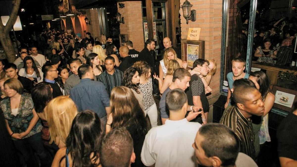 Crowds pack the area in front of MoTav on Higuera Street in downtown San Luis Obispo early on a Saturday morning in May 2011.