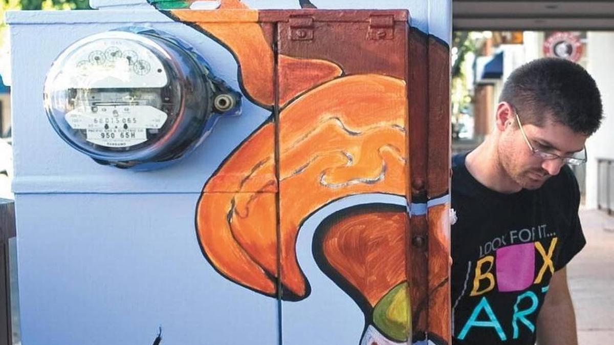Justin Johnson paints a utility box in September 2010 near Chorro and Higuera streets in downtown San Luis Obispo. The acrylic work is called “Topagraphical Abstract.” The utility box is one of 17 boxes originally painted in 2010.