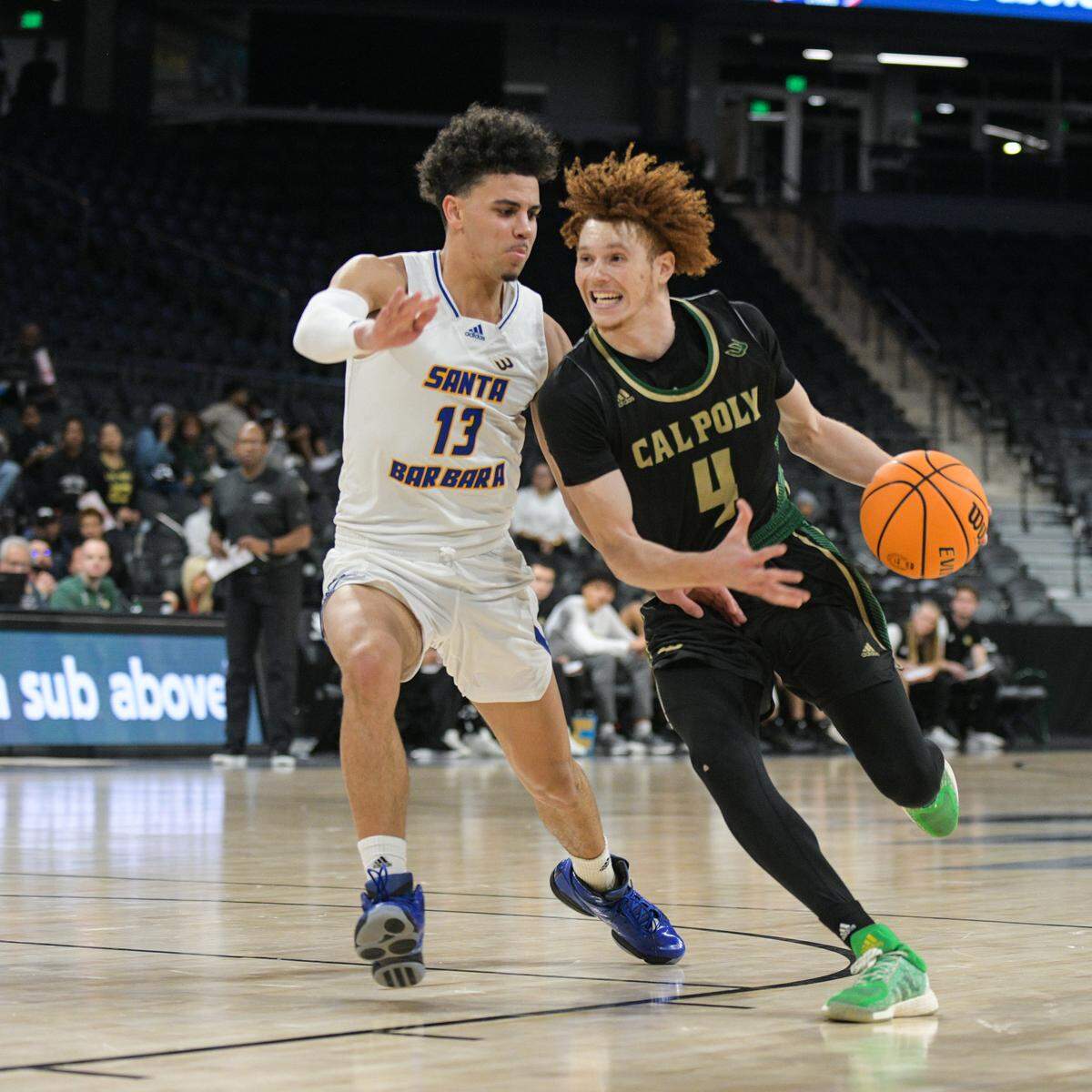 Brantly Stevenson drives against Ajay Mitchell in Cal Poly’s 64-54 loss to UCSB in the Big West men’s basketball tournament at Dollar Dollar Loan Center in Henderson, Nevada, on March 9, 2023.