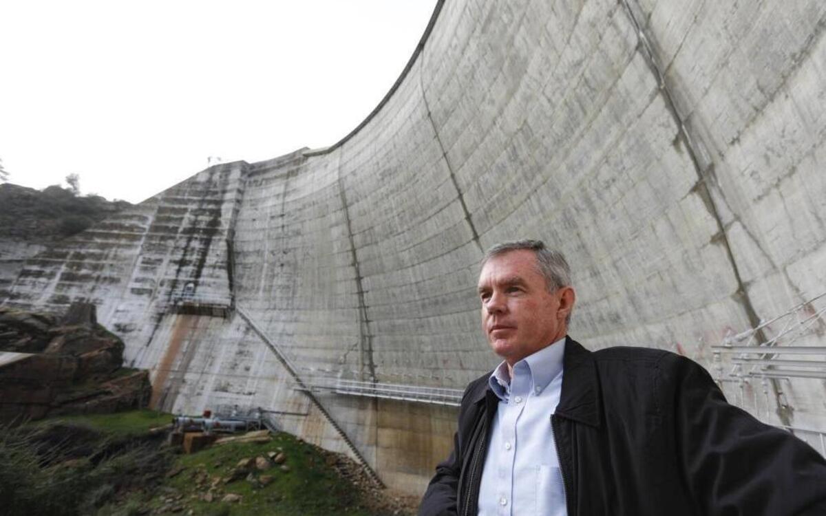 Mark Hutchinson, deputy director of San Luis Obispo County public works, stands below the Salinas Dam earlier this month when Santa Margarita Lake filled for the first time in years.