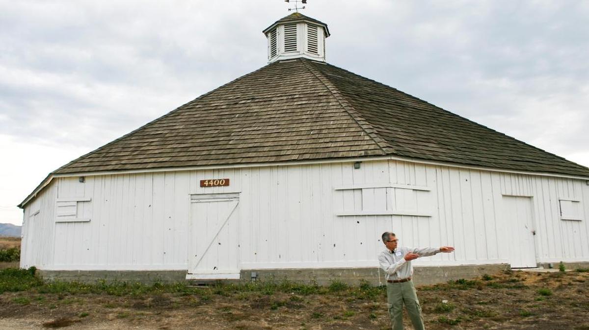 Pete Jenny, Land Conservancy trustee, directs traffic at a meeting Wednesday to discuss restoration efforts at the Octagon Barn in San Luis Obispo.